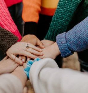 People connecting their hands